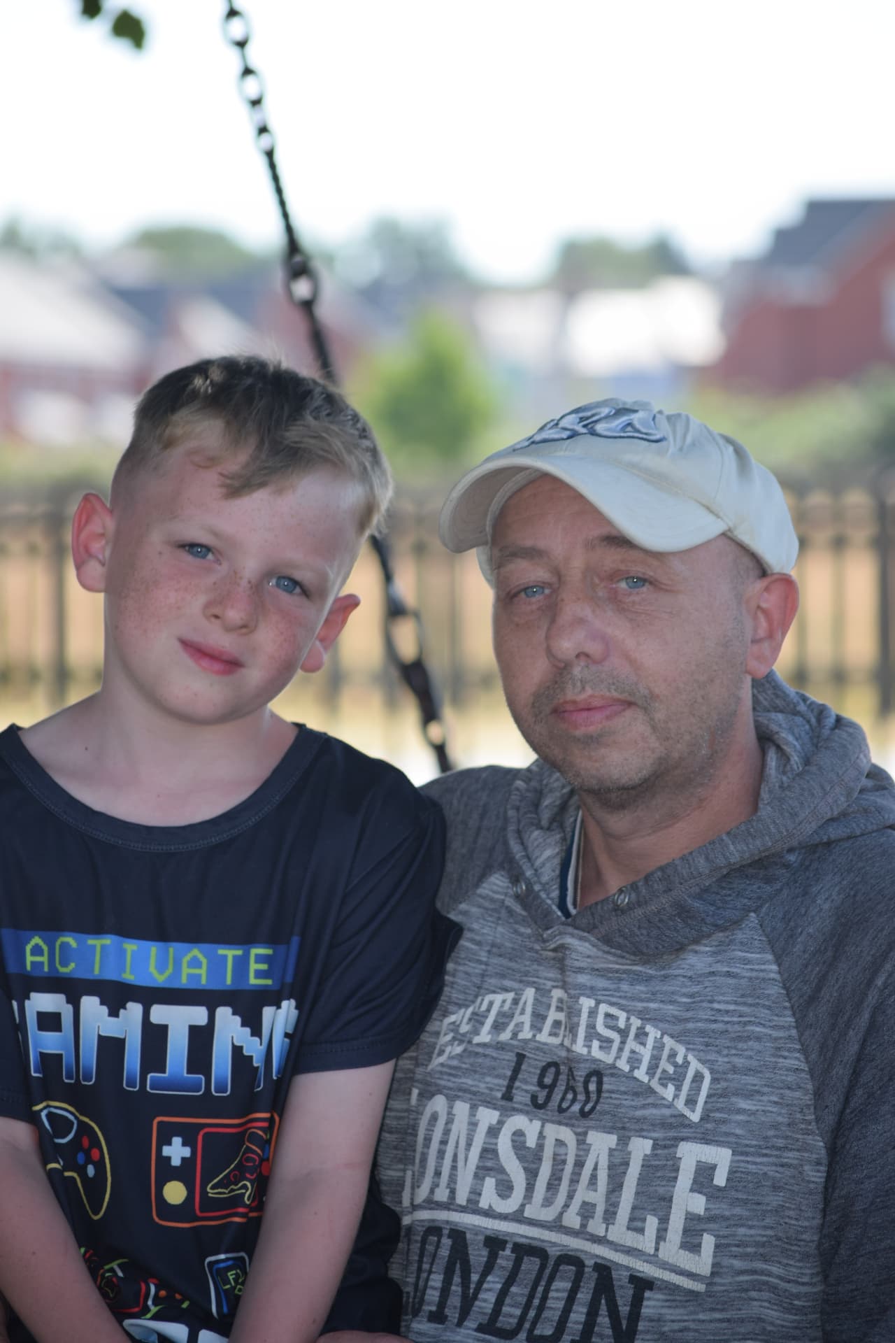 Father and son on a park swing