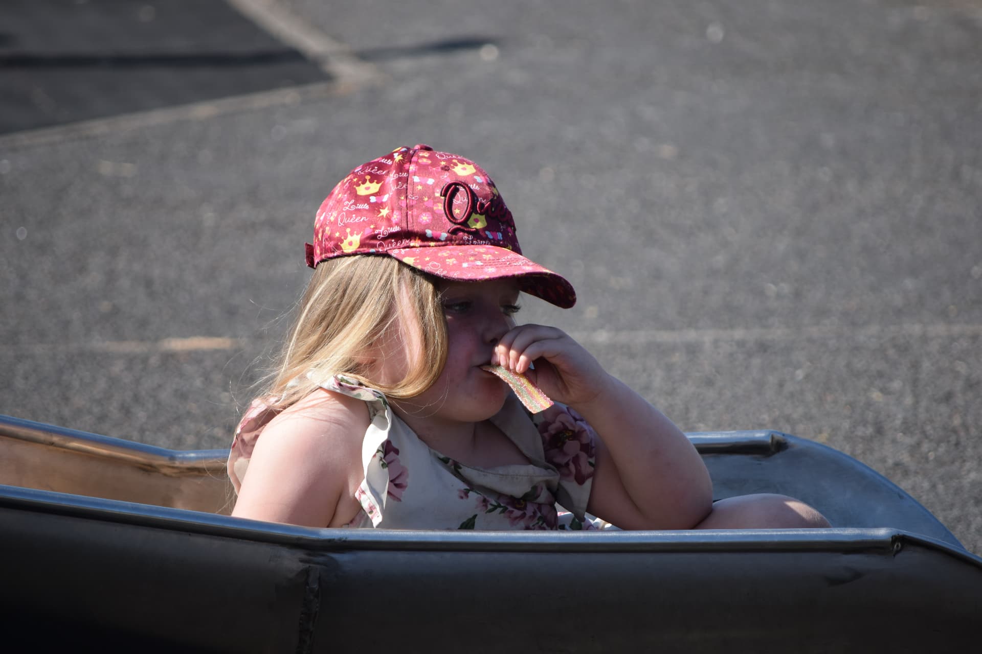 Girl enjoying sweets on a fairground ride